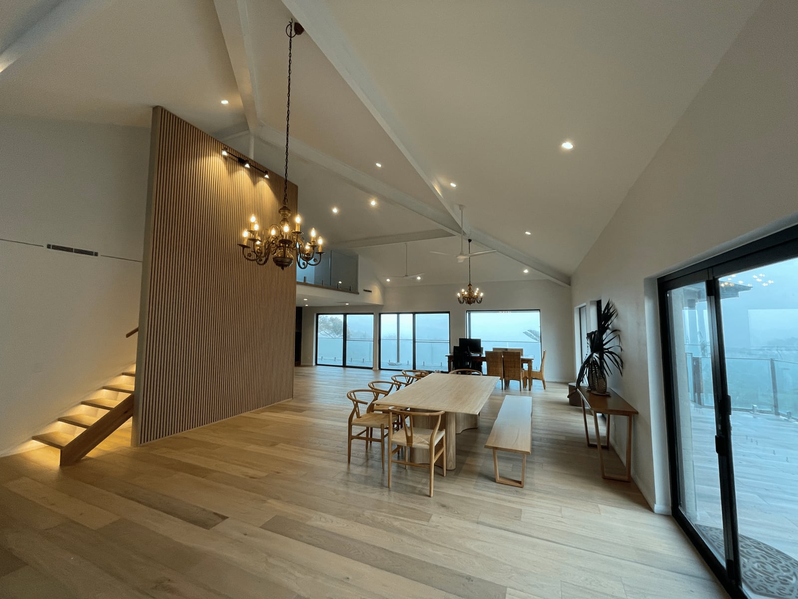 Cathedral ceiling with feature pendant lighting and recessed downlights