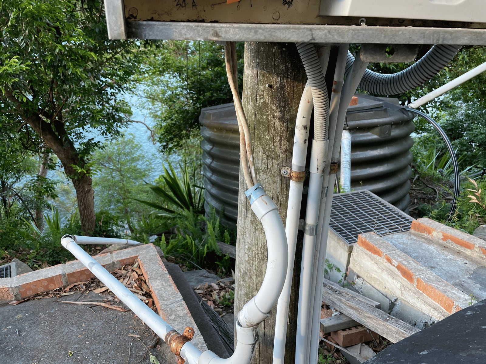 Conduit and cabling running to a meter box mounted on a timber pole