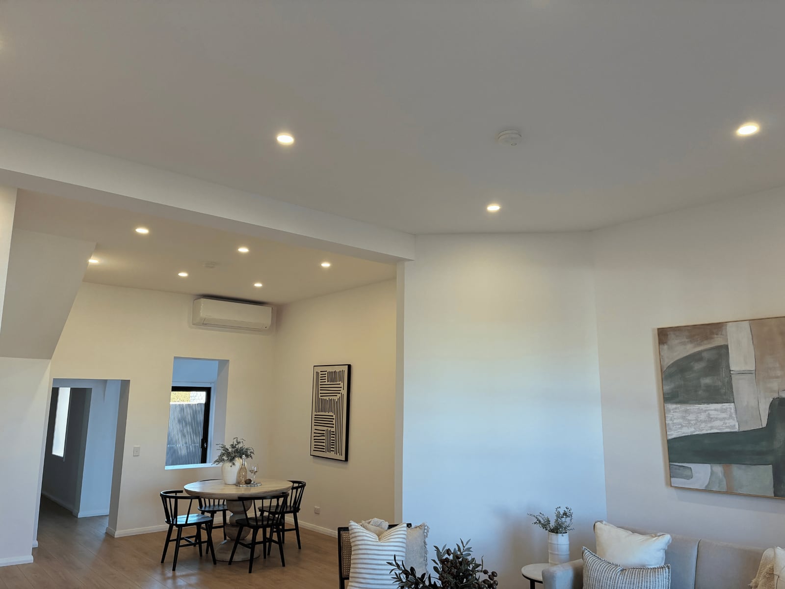 Finished open-plan living and dining area with recessed LED downlights