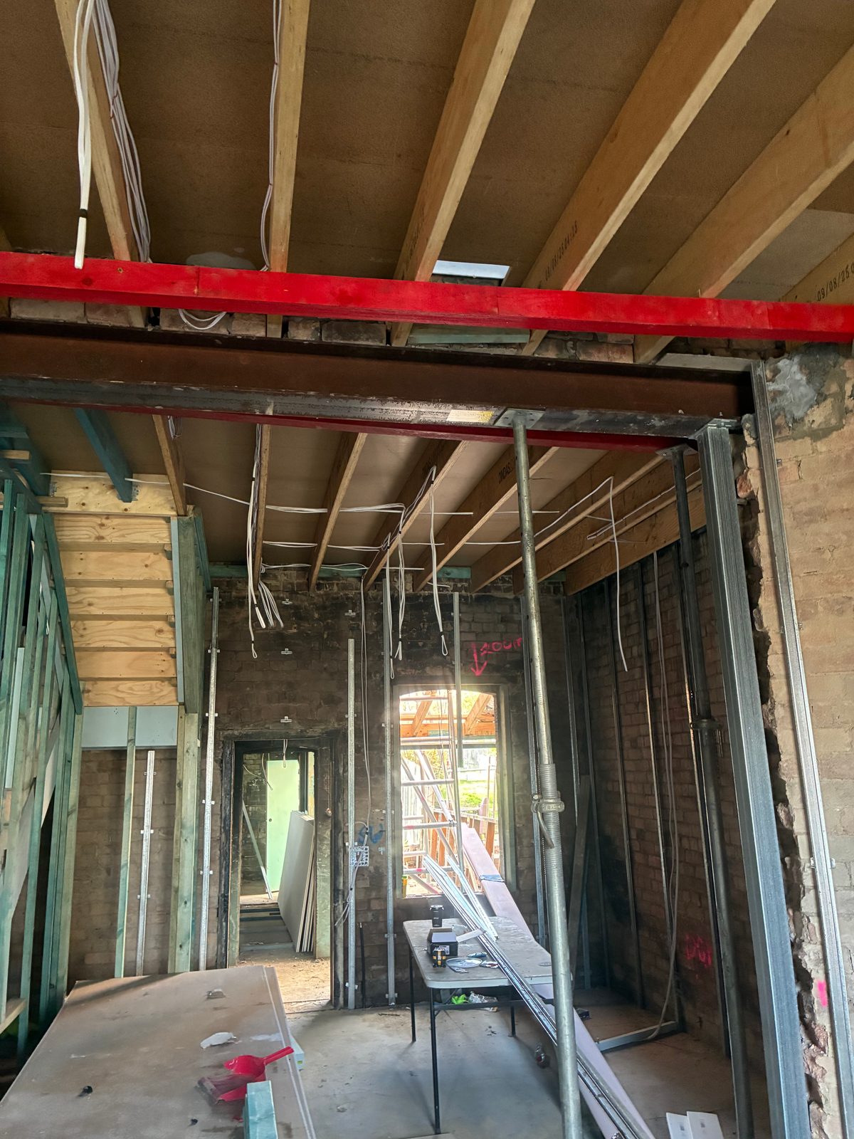 Renovation interior with new wiring run through exposed ceiling joists