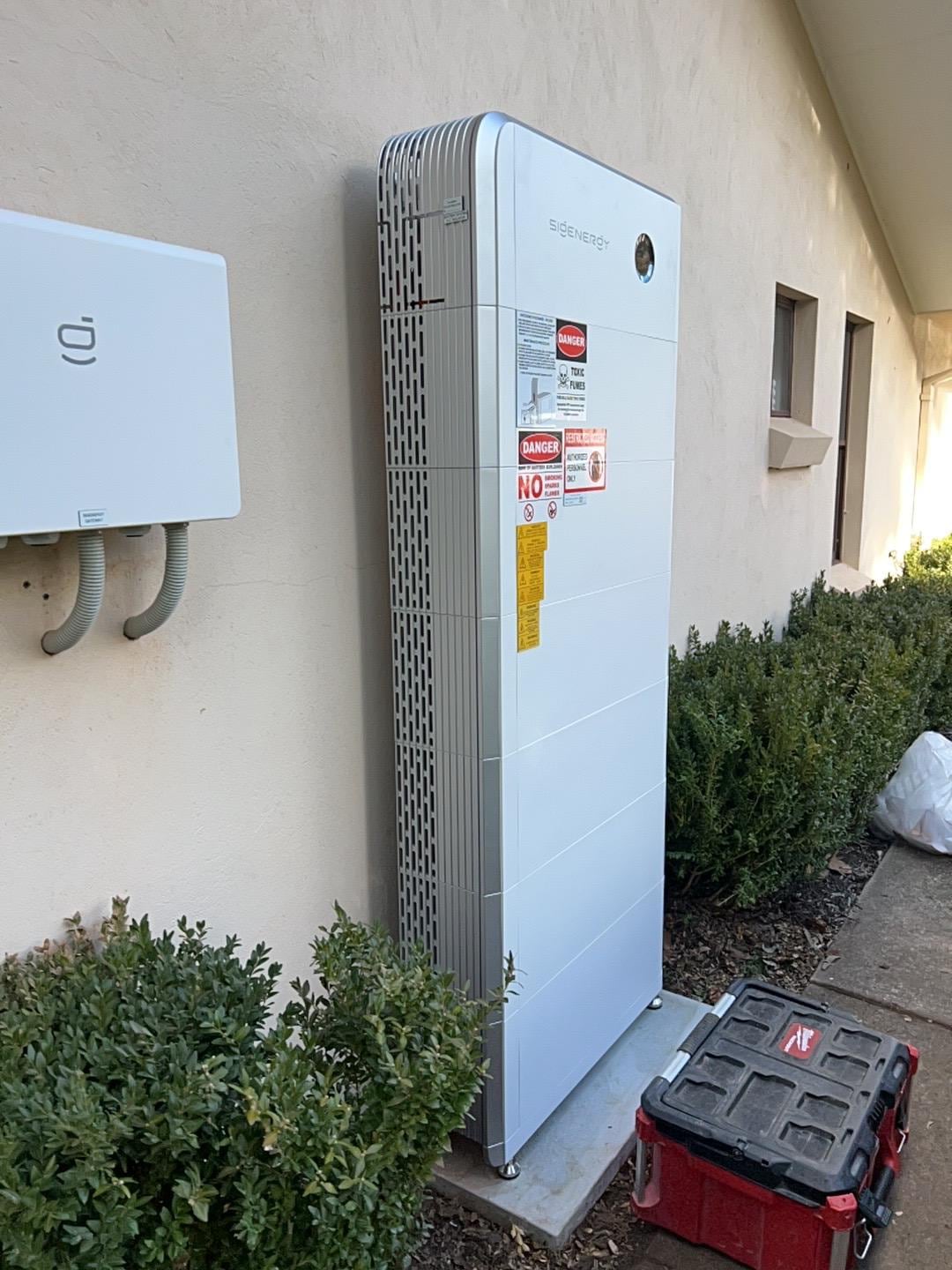 Home battery storage system installed on an exterior wall