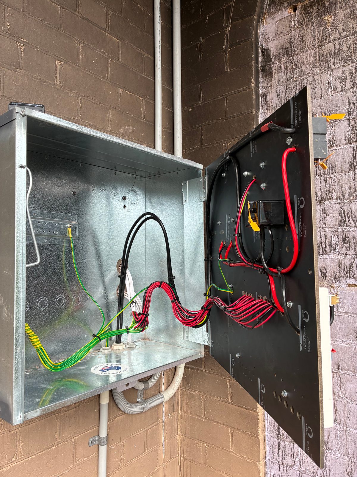 Open switchboard enclosure with newly run circuit wiring